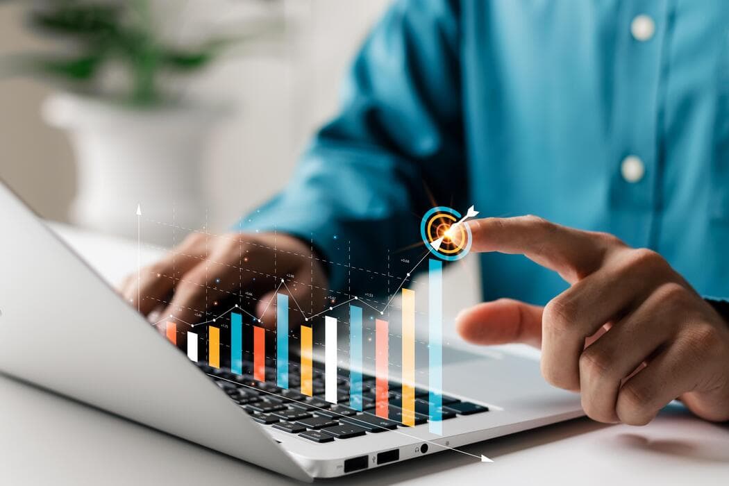Business owner reviewing growth charts on a laptop